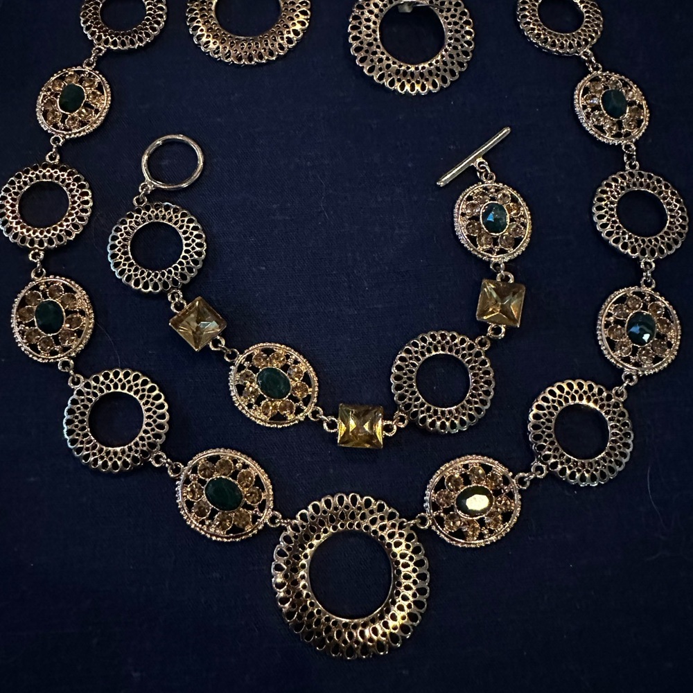 Gold set with green and yellow stones